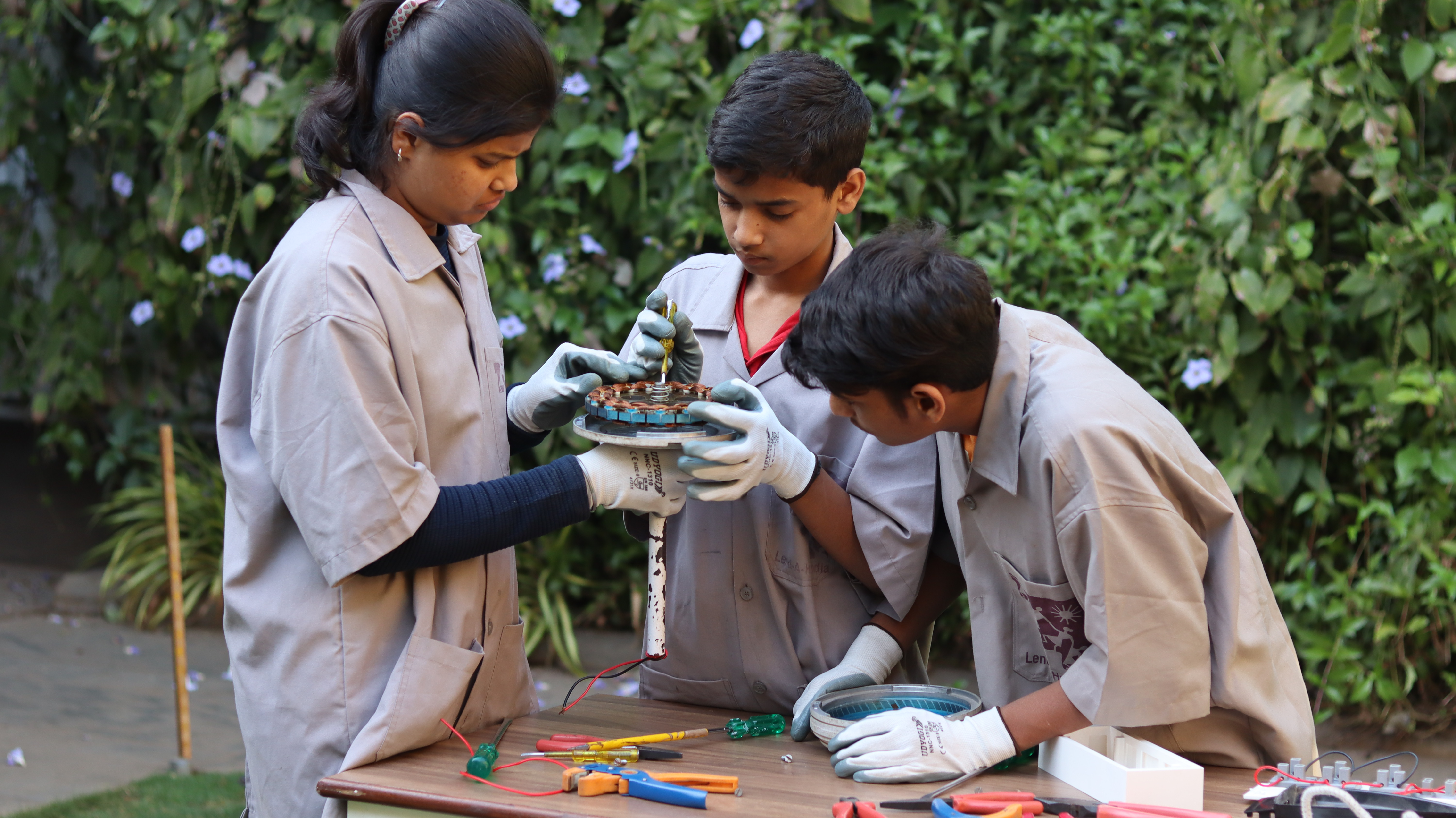 School Children at Karigar School of Applied Learning repairing a fan